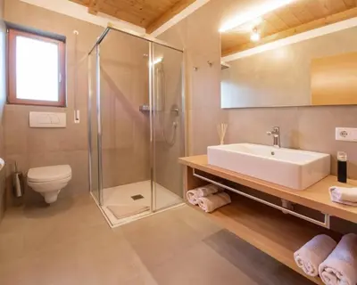 a bathroom with a sink and a shower and a toilet at Appartements St Urban in Cornaiano