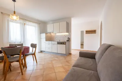 a living room with a couch and a table at Appartements St Urban in Cornaiano