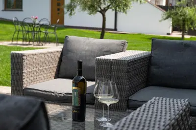 a bottle of wine sitting on a table with a glass at Appartements St Urban in Cornaiano