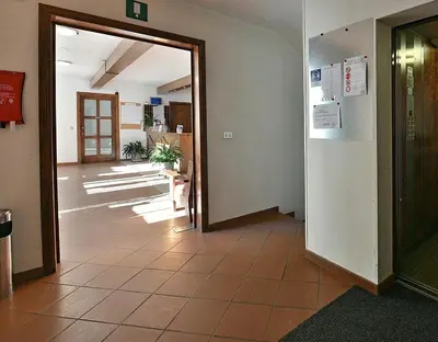 an office hallway with a door leading into a room at Santa Cristina SudTirol SassLong Flat in Santa Cristina in Val Gardena