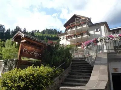 a building with stairs in front of a building at Santa Cristina SudTirol SassLong Flat in Santa Cristina in Val Gardena