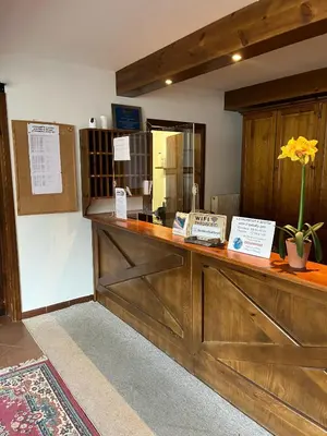 a large wooden counter with a vase of flowers on it at Santa Cristina SudTirol SassLong Flat in Santa Cristina in Val Gardena