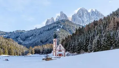 a small church in the middle of a snow covered mountain at Dolomiten Home in Villnoss