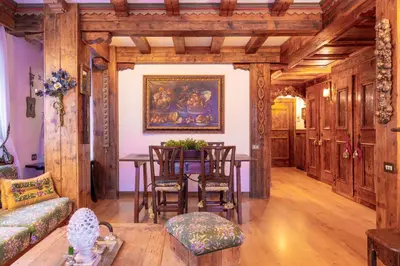 a living room with a table and chairs at Cortina City Center Alpine Apartment with Private Garage in Cortina dʼAmpezzo