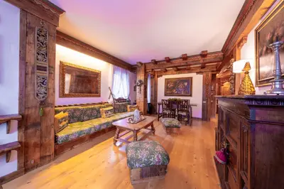 a living room with a couch and a table at Cortina City Center Alpine Apartment with Private Garage in Cortina dʼAmpezzo