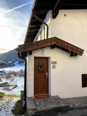 a house with a brown door on the side of it at Ciasa Coderoppola in Moena