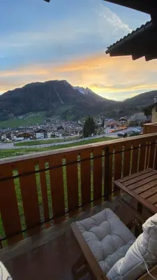 a balcony with a table and a view of a city at Ciasa Coderoppola in Moena