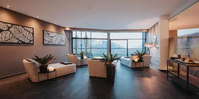 a living room with couches and a large window at La Vista Panoramic Hideaway - Adults only in Tirolo