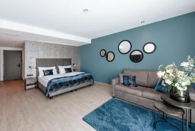 a bedroom with a bed and a couch at La Vista Panoramic Hideaway - Adults only in Tirolo