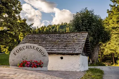 a building with a sign that says chaterance at Forchnerhof Nature & Mountain View Apartments in Terento