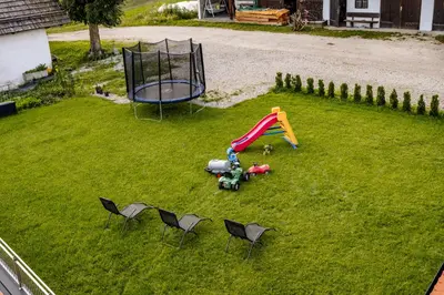 an aerial view of a playground with chairs and a slide at Forchnerhof Nature & Mountain View Apartments in Terento