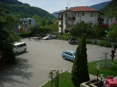 a parking lot with several cars parked in it at Hotel & Residence Sylvanerhof in Chiusa
