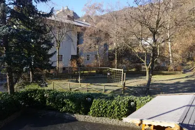 a house with a fence in front of a yard at Hotel & Residence Sylvanerhof in Chiusa