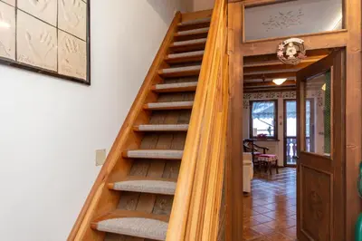 a wooden staircase leading up to a house at Chalet Kalipe in Rocca Pietore