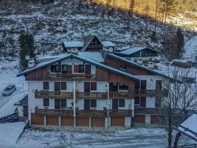 a large house in the snow with snow at Chalet Kalipe in Rocca Pietore