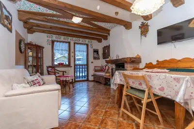 a living room with a couch and a table at Chalet Kalipe in Rocca Pietore