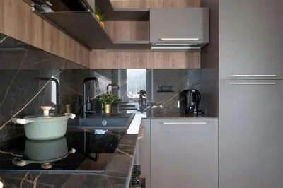 a kitchen with a sink and a counter at GuestHost - Dolomite Elegance - Chic Flat in San Vito di Cadore in Termine