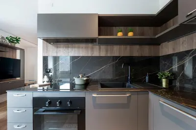 a kitchen with a sink and a stove at GuestHost - Dolomite Elegance - Chic Flat in San Vito di Cadore in Termine
