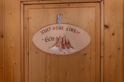 a small room with a wooden table and two chairs at Suite Tre Cime in Alleghe