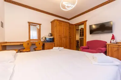 a kitchen with wooden cabinets and a sink at Suite Tre Cime in Alleghe