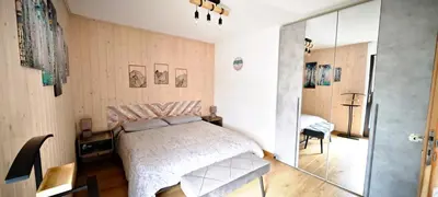 a bedroom with a bed and a glass wall at Casa Cermis in Cavalese