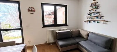 a bedroom with a bed and a wall with paintings at Casa Cermis in Cavalese