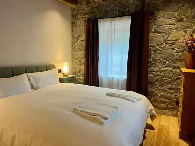 a bedroom with a bed with towels on it at Casa Alice in Rocca Pietore