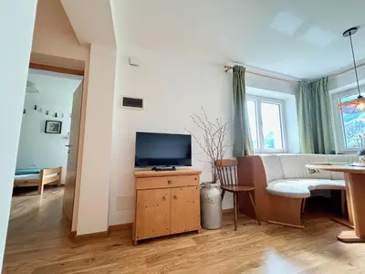 a living room with a television on a wooden cabinet at Haslingerhof - Ferienwohnung Hirzer in Saltusio
