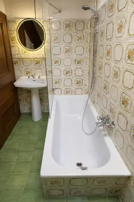 a bathroom with a tub and a sink at Cà Masariè Alverà in Cortina dʼAmpezzo