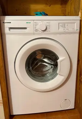 a white washing machine with its door open at Cà Masariè Alverà in Cortina dʼAmpezzo
