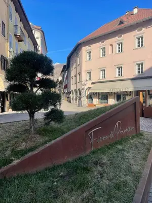 a sign in the grass next to a building at SASS MAOR 2 bedrooms apartment 80 sm Fiera di Primiero TN in Fiera di Primiero