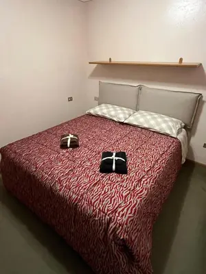 a bedroom with a bed with two black bags on it at SASS MAOR 2 bedrooms apartment 80 sm Fiera di Primiero TN in Fiera di Primiero