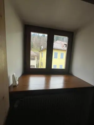 a window in a room with a wooden window sill at SASS MAOR 2 bedrooms apartment 80 sm Fiera di Primiero TN in Fiera di Primiero