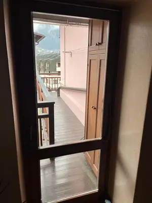 a view through a glass door of a balcony at SASS MAOR 2 bedrooms apartment 80 sm Fiera di Primiero TN in Fiera di Primiero