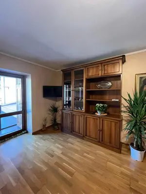 a large living room with wooden floors and a large window at SASS MAOR 2 bedrooms apartment 80 sm Fiera di Primiero TN in Fiera di Primiero