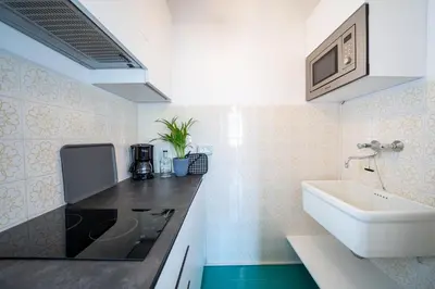 a bathroom with a sink and a white sink at Am See Apartments in Castelvecchio