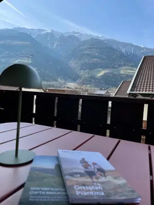 two cups sitting on a table with a view of mountains at Haus Stadler in Naturno