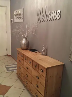 a wooden dresser with a vase on top of it at Apartment Sofia in Mühlbach