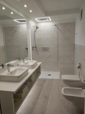 a bathroom with two sinks and a shower at Apartment Sofia in Mühlbach