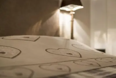 a bed with hearts painted on it with a lamp at Apartment Sofia in Mühlbach