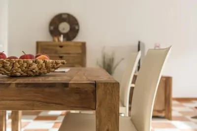 a wooden table with a bowl of apples on it at Apartment Sofia in Mühlbach