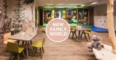 a new family world restaurant with tables and a teddy bear at Falkensteiner Hotel Falkensteinerhof l 4 Star Superior in Valles