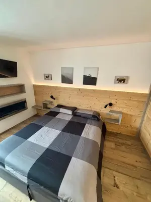 a bedroom with a bed in a room at Pragma Apartments - Fiore delle Alpi in Bellamonte
