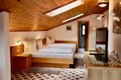 a bedroom with a bed and a desk in it at Oberortsgut in Tirolo