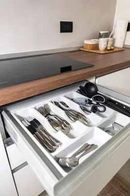 a stove top oven with silver utensils at Appartamento Alpino Cles in Cles