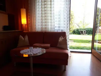 a living room with a couch and a glass table at Ferienwohnungen Hofanger in Lagundo