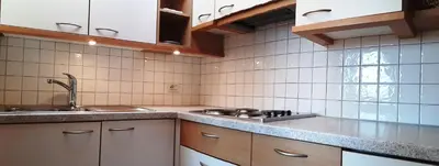 a kitchen with a sink and a stove at Ferienwohnungen Hofanger in Lagundo