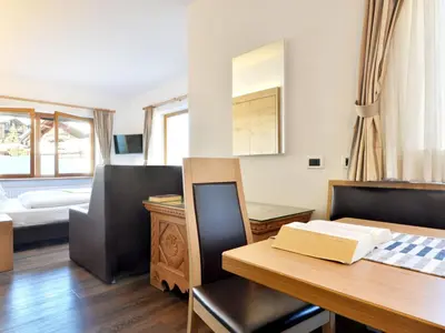 a bedroom with two beds and a black headboard at Holiday Home Kostner-2 by Interhome in Bulla
