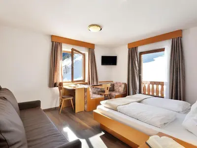 a bedroom with two beds and a large window at Holiday Home Kostner-2 by Interhome in Bulla
