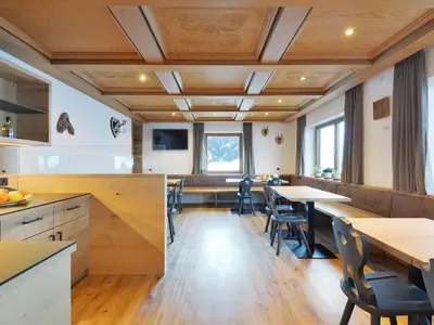 a living room with a large television and a hallway at Holiday Home Kostner-2 by Interhome in Bulla